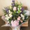 Touch of Love hand tied bouquet in water in pinks & purples